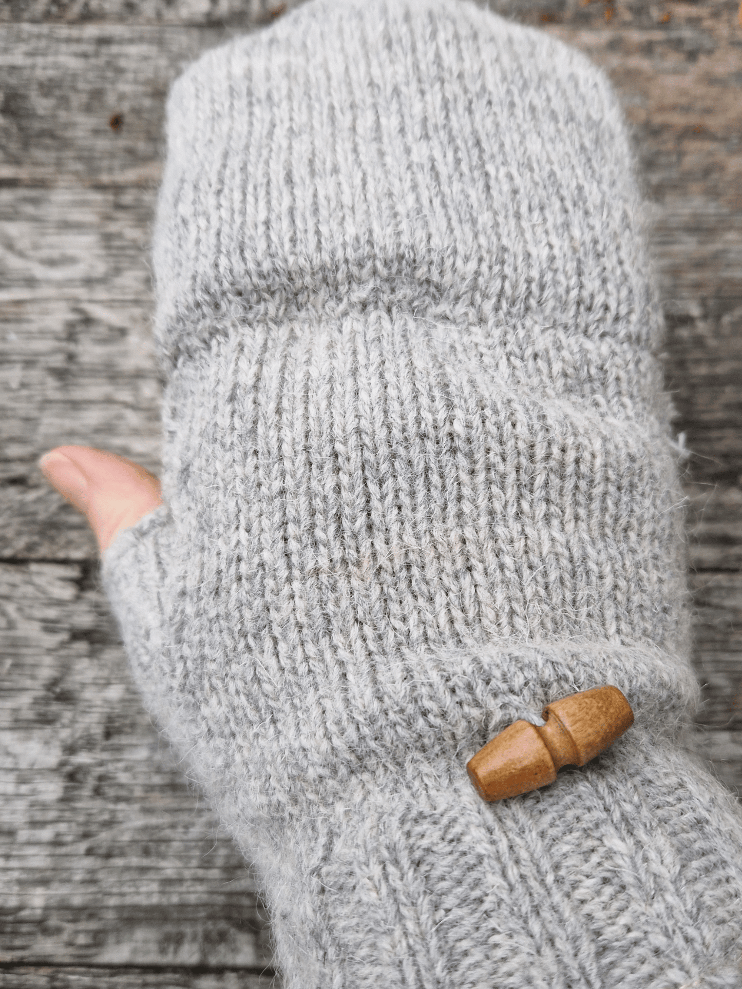 button detail on back of grey knitted mittens