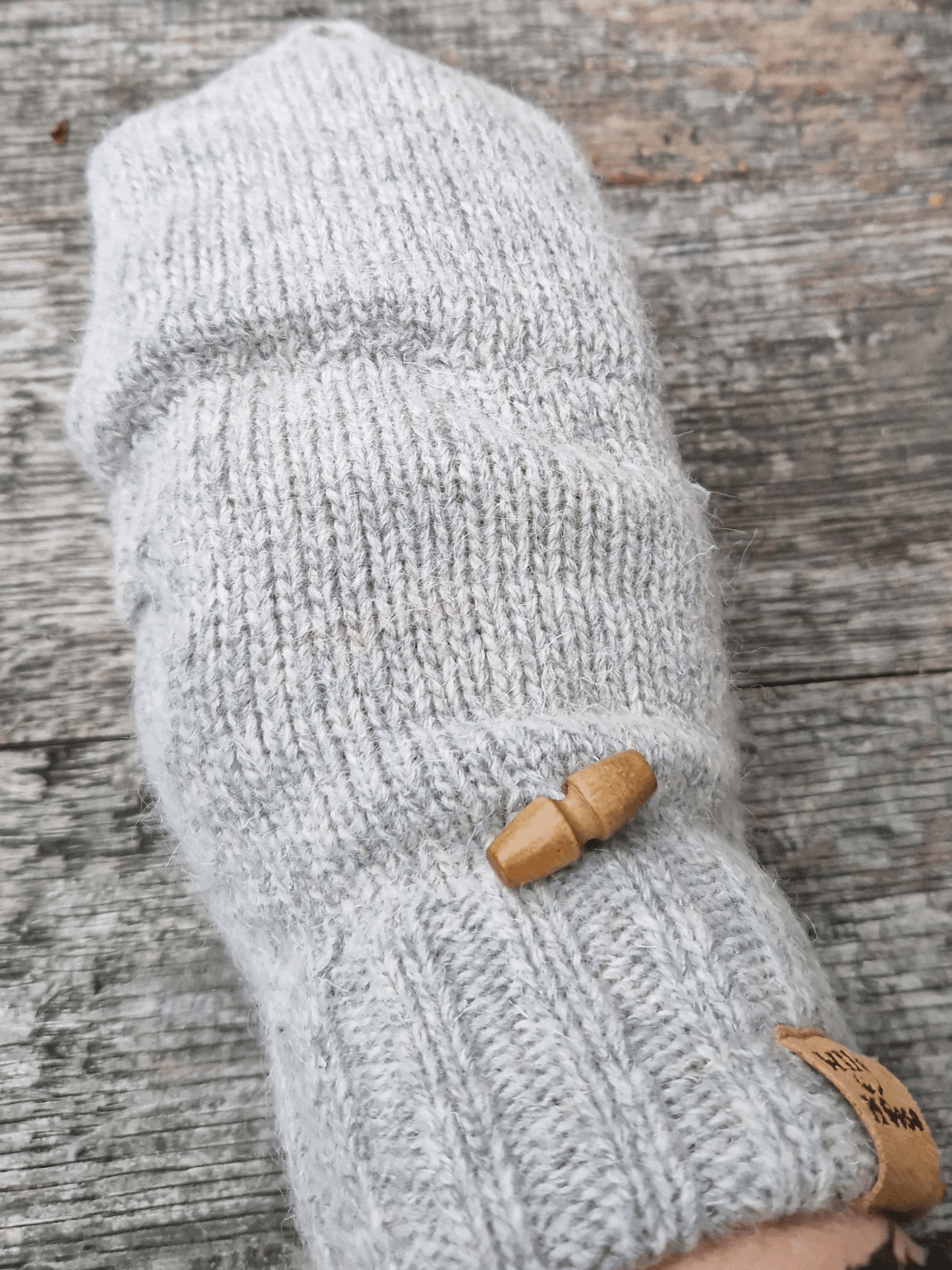 button detail on grey mittens