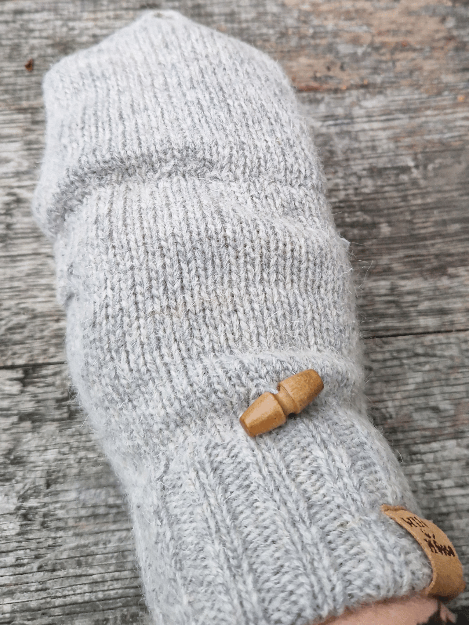 button detail on grey mittens