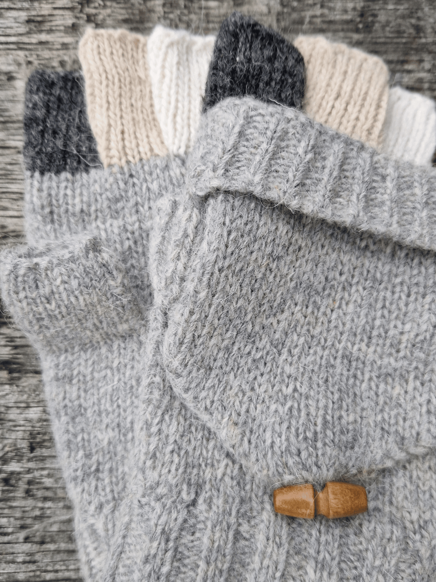 knitted grey finglerless gloves