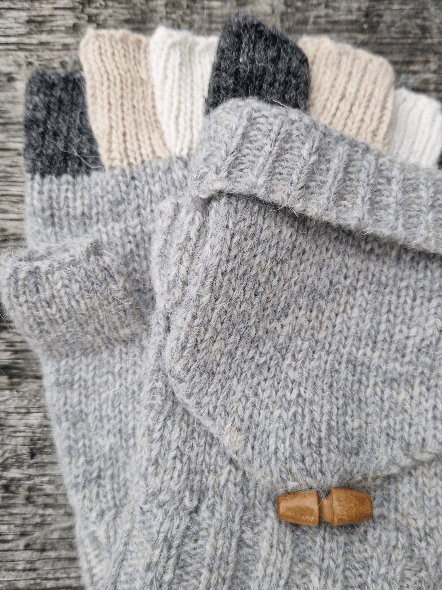 knitted grey finglerless gloves