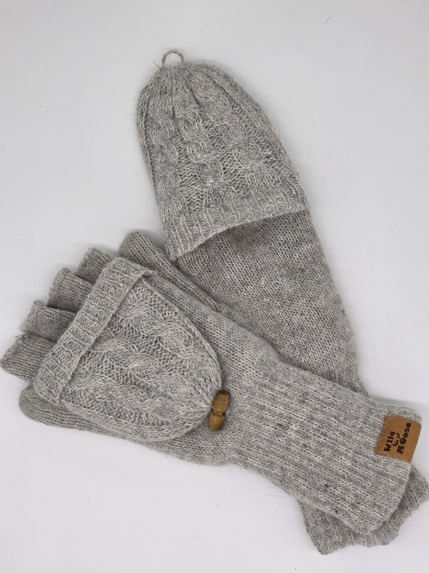 2 grey mittens one fingerless and one with the "hood" of the glove folded over on a white background.