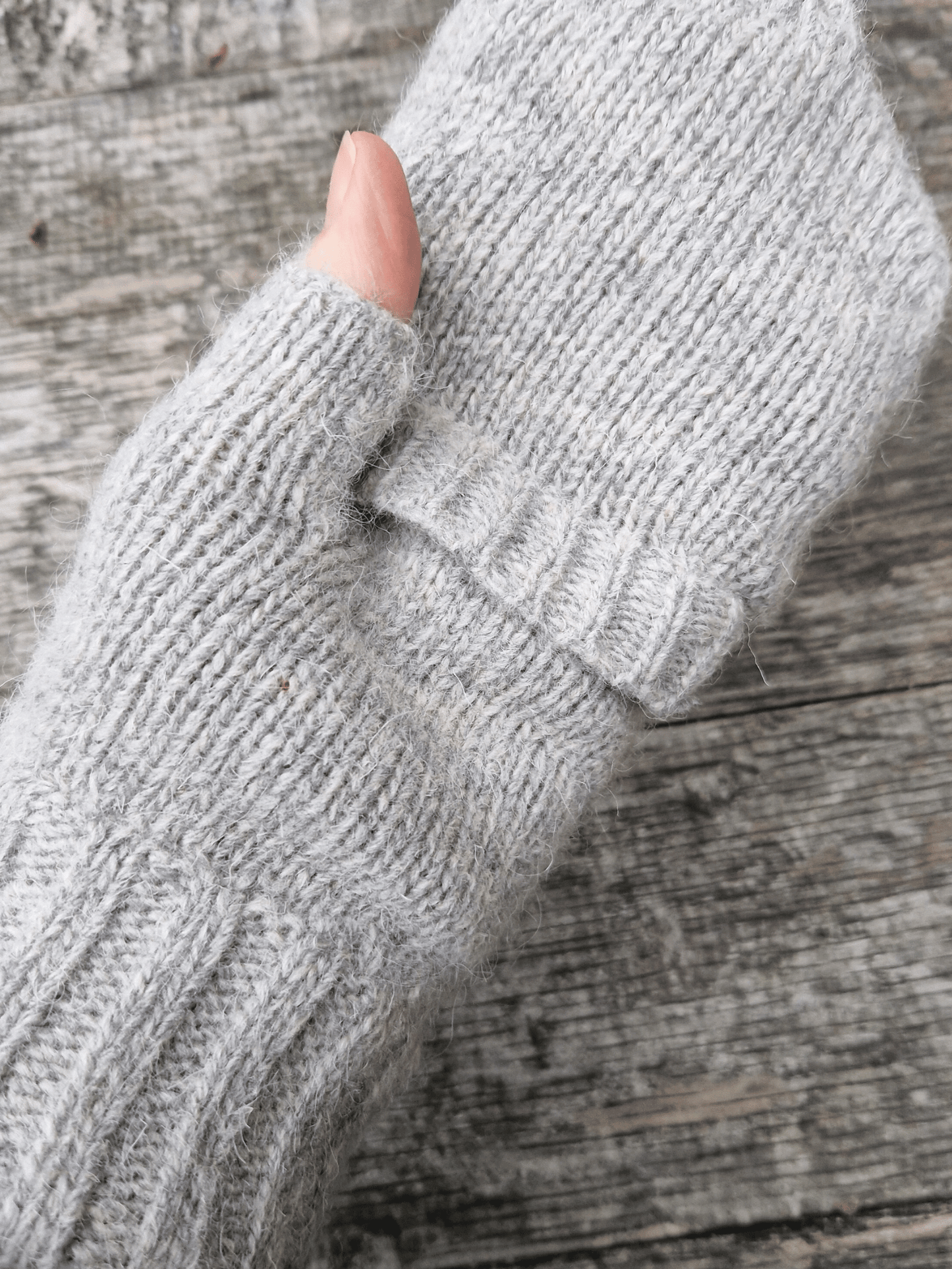 mitten top folded over on knitted fingerless gloves