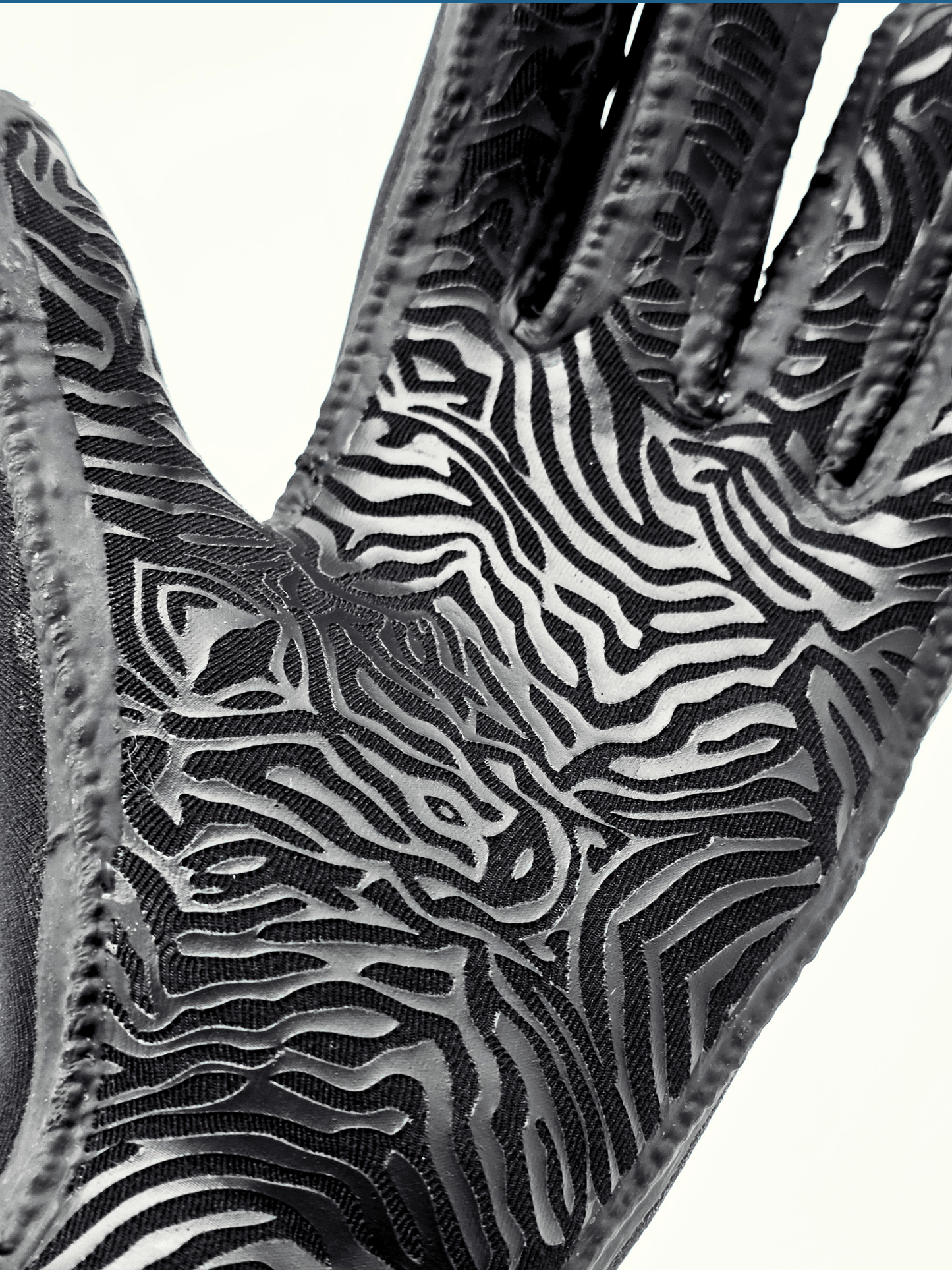 back animal print pattern on palm of glove shown o a white background.