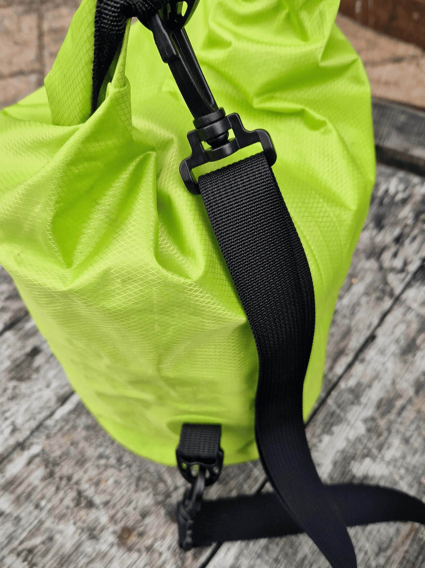 close up of shoulder strap of neon green 5L dry bag