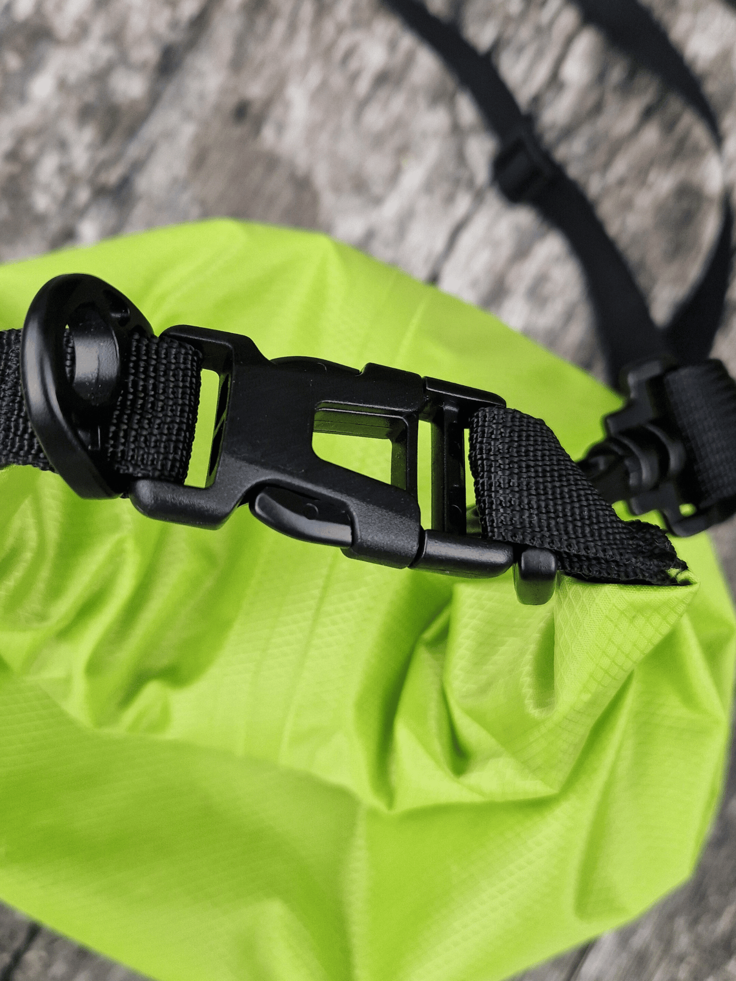 close up of top buckle of neon green 5L dry bag