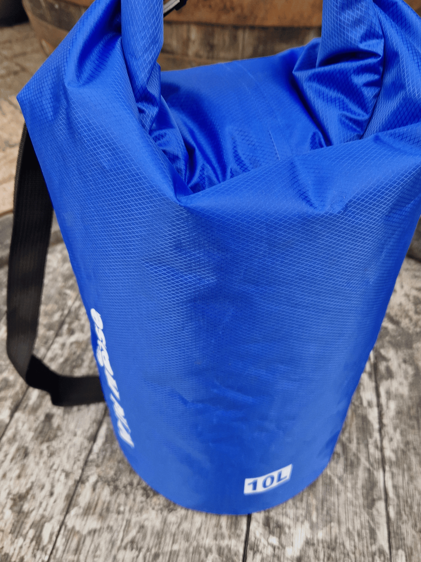 10L blue dry bag with a visible Wild Moose brand logo on a wooden surface