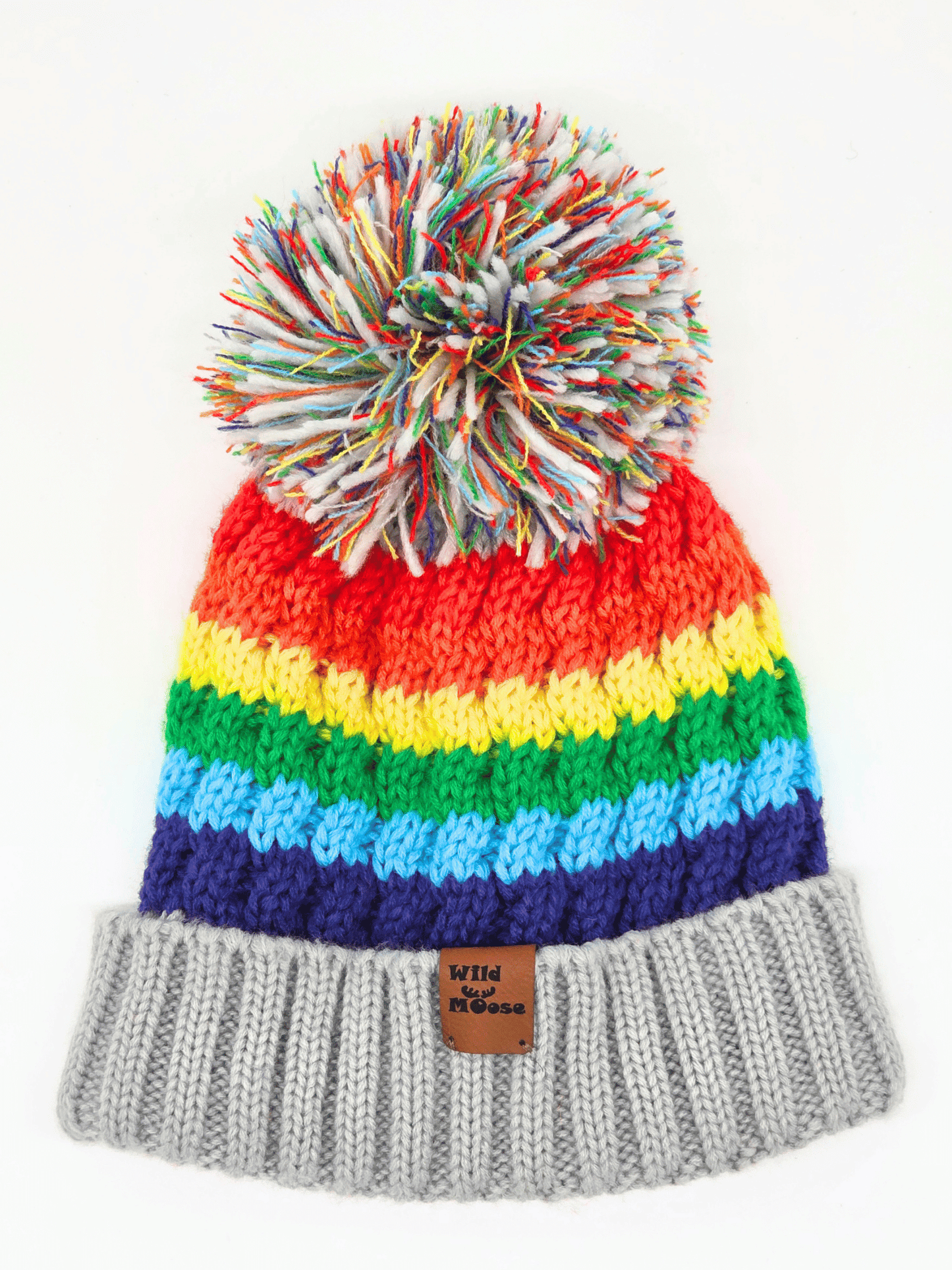 multicoloured beanie in a rainbow order and a pom-pom on a white background.