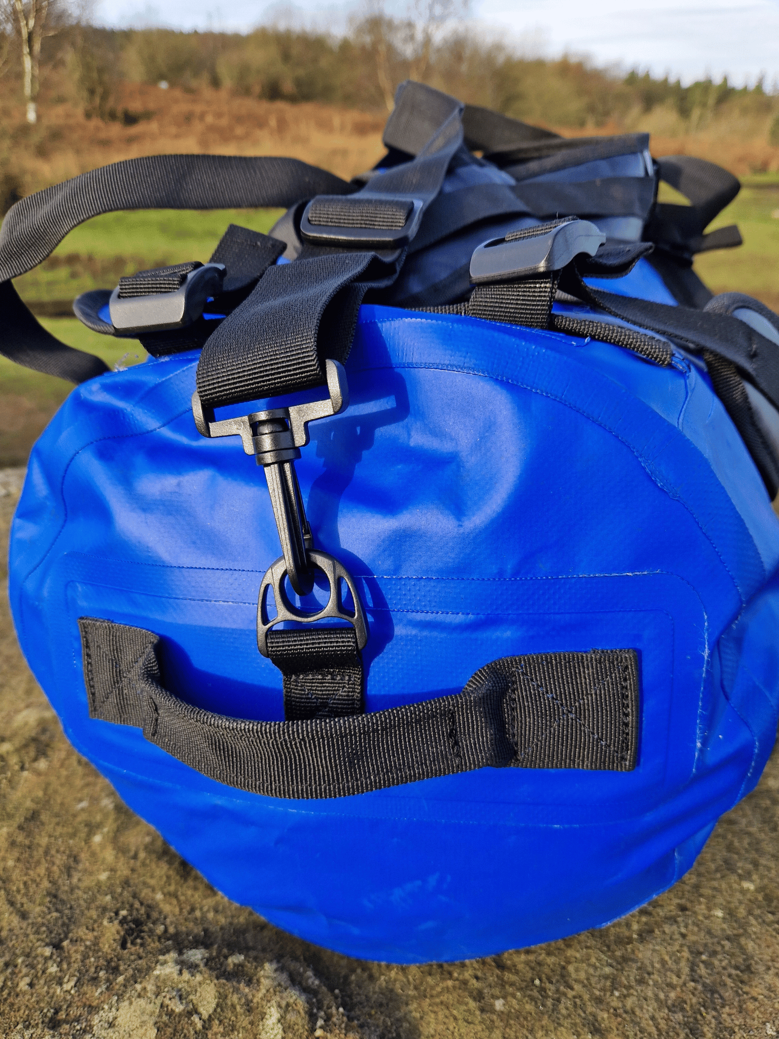 close up of the end of the blue duffel bag to show the grab handles