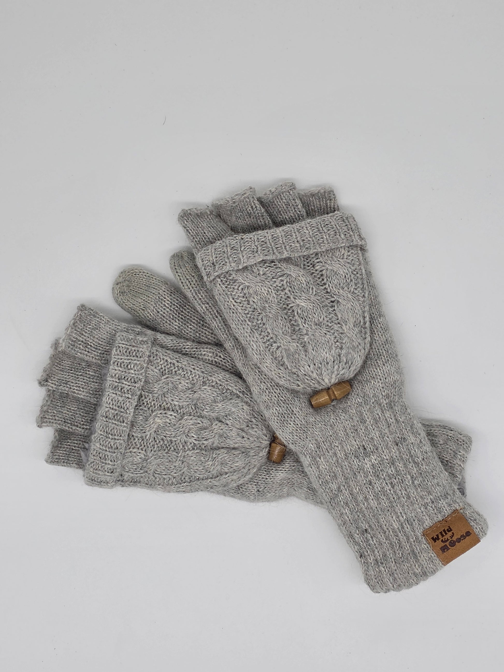 grey knit fingerless mittens on a white background.