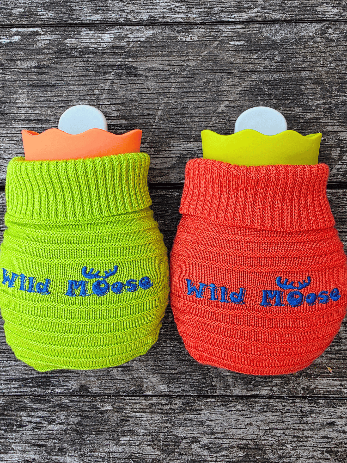 2 mini hot water bottles in a contrasting knitted cover - one bright orange the other bright green
