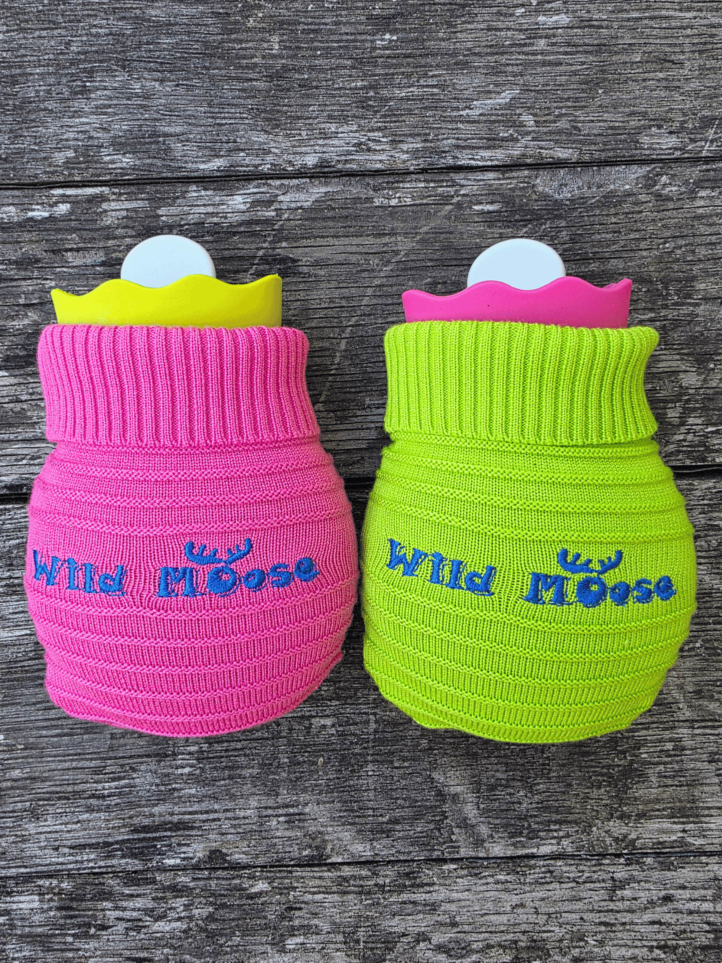 2 mini hot water bottles in a contrasting knitted cover - one bright pink the other bright green