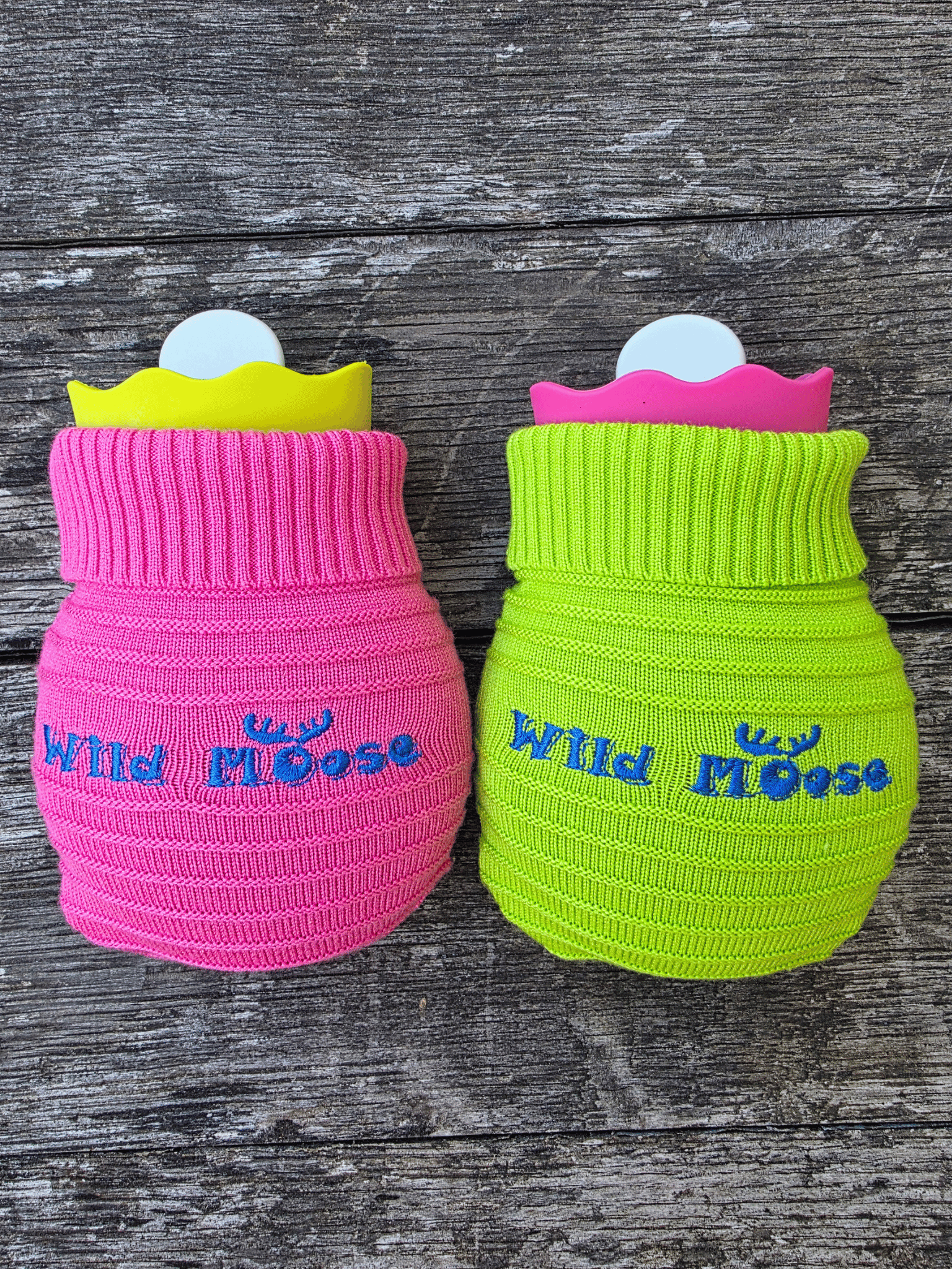 2 mini hot water bottles in a contrasting knitted cover - one bright pink the other bright green