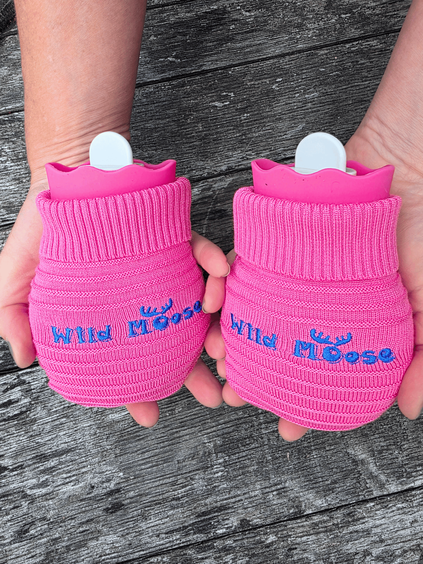 2 mini hot water bottles in a knitted cover - both bright pink