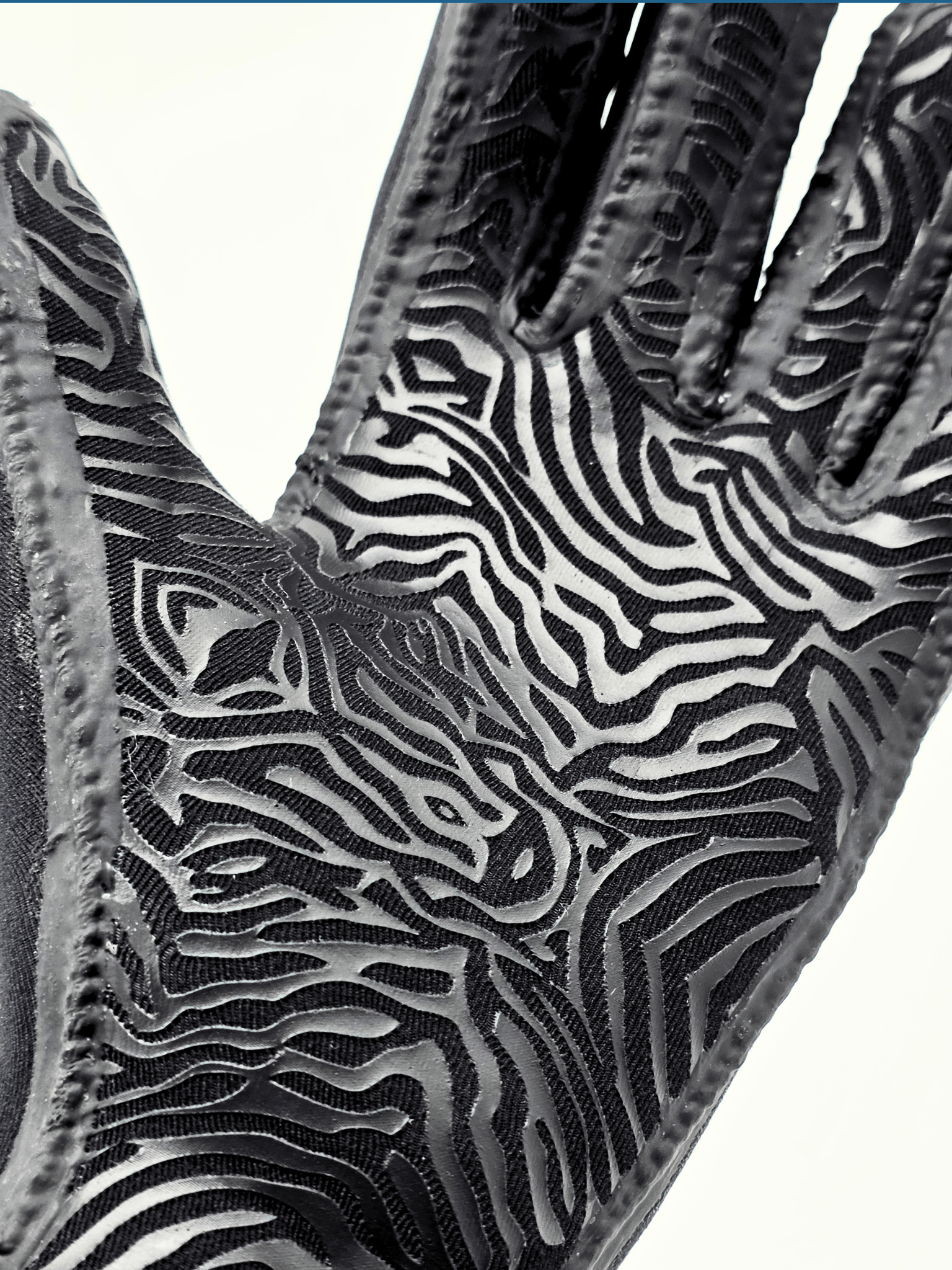 back animal print pattern on palm of glove shown o a white background.