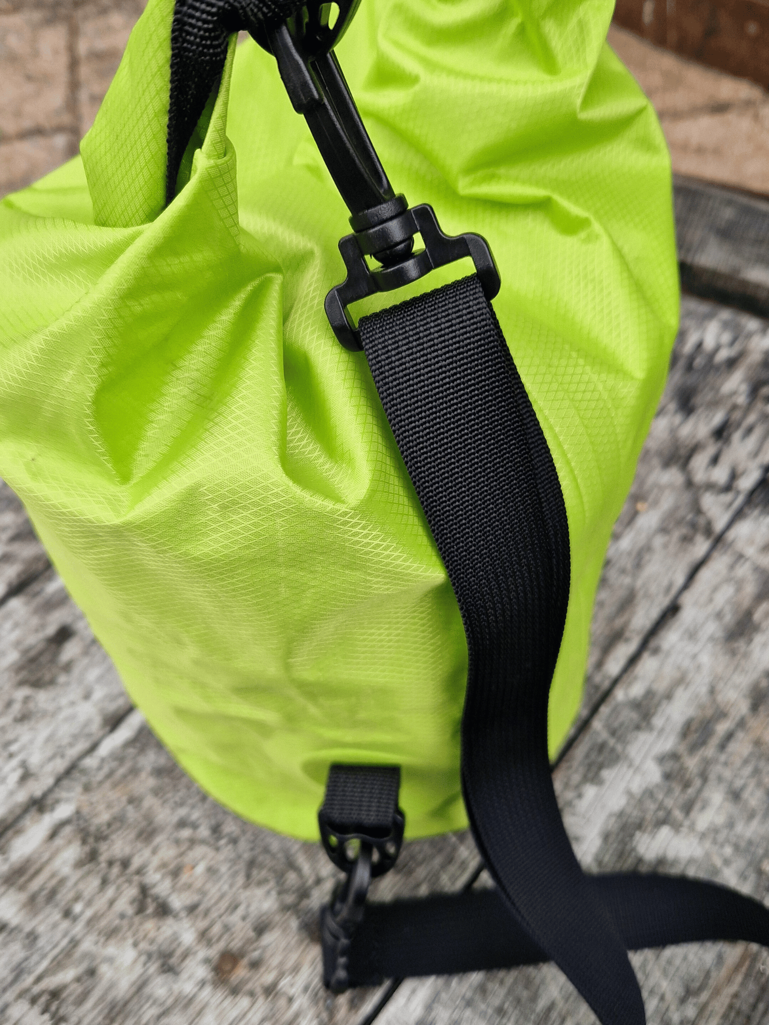 close up of shoulder strap of neon green 5L dry bag