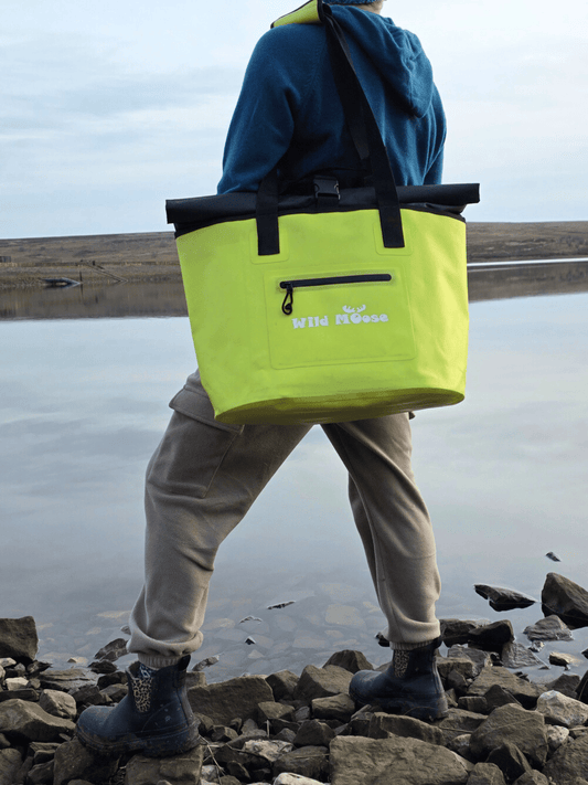 lime yellow tote bag on a woman's shoulder as she stands by a lake