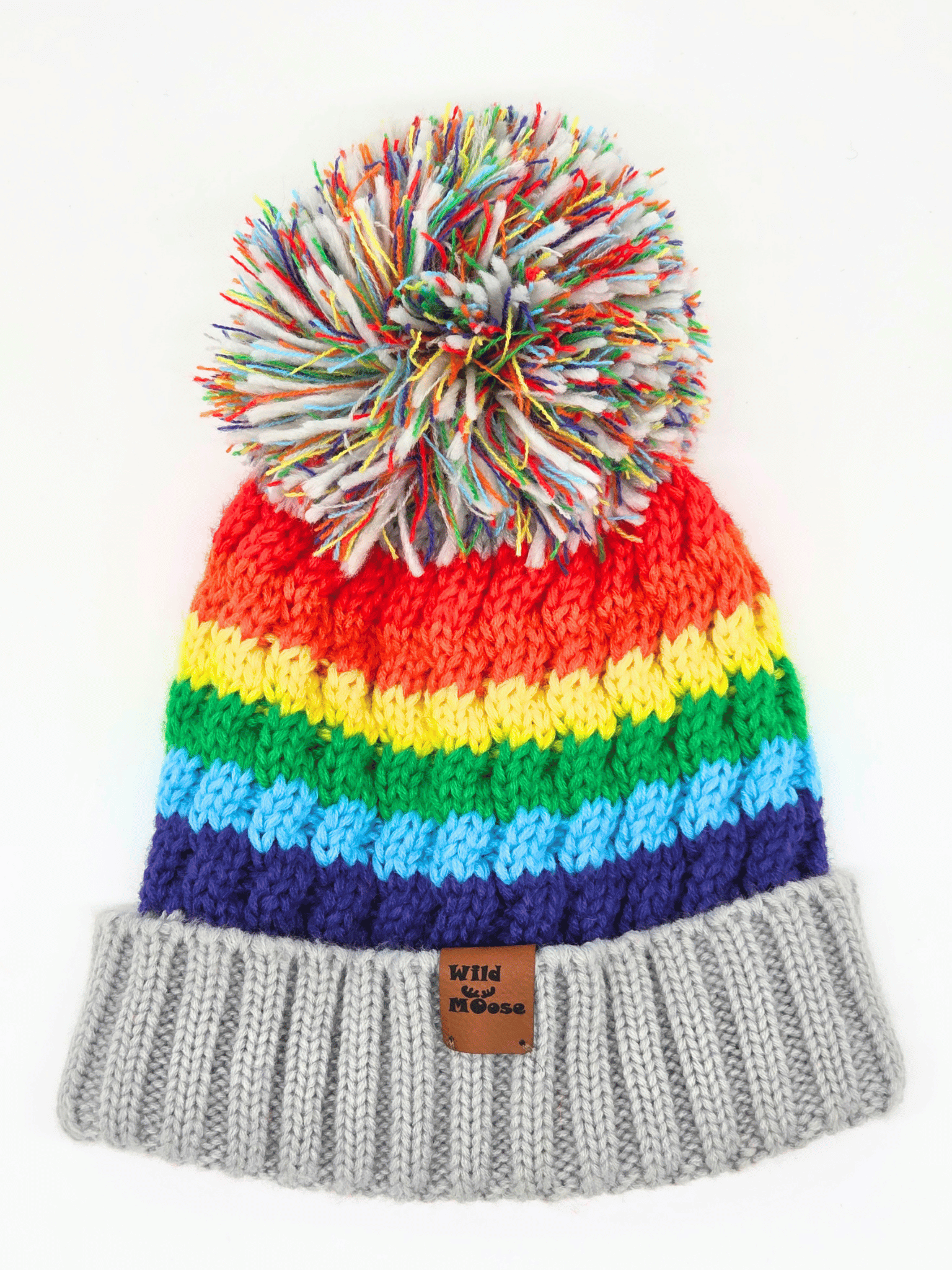 multicoloured beanie in a rainbow order and a pom-pom on a white background.