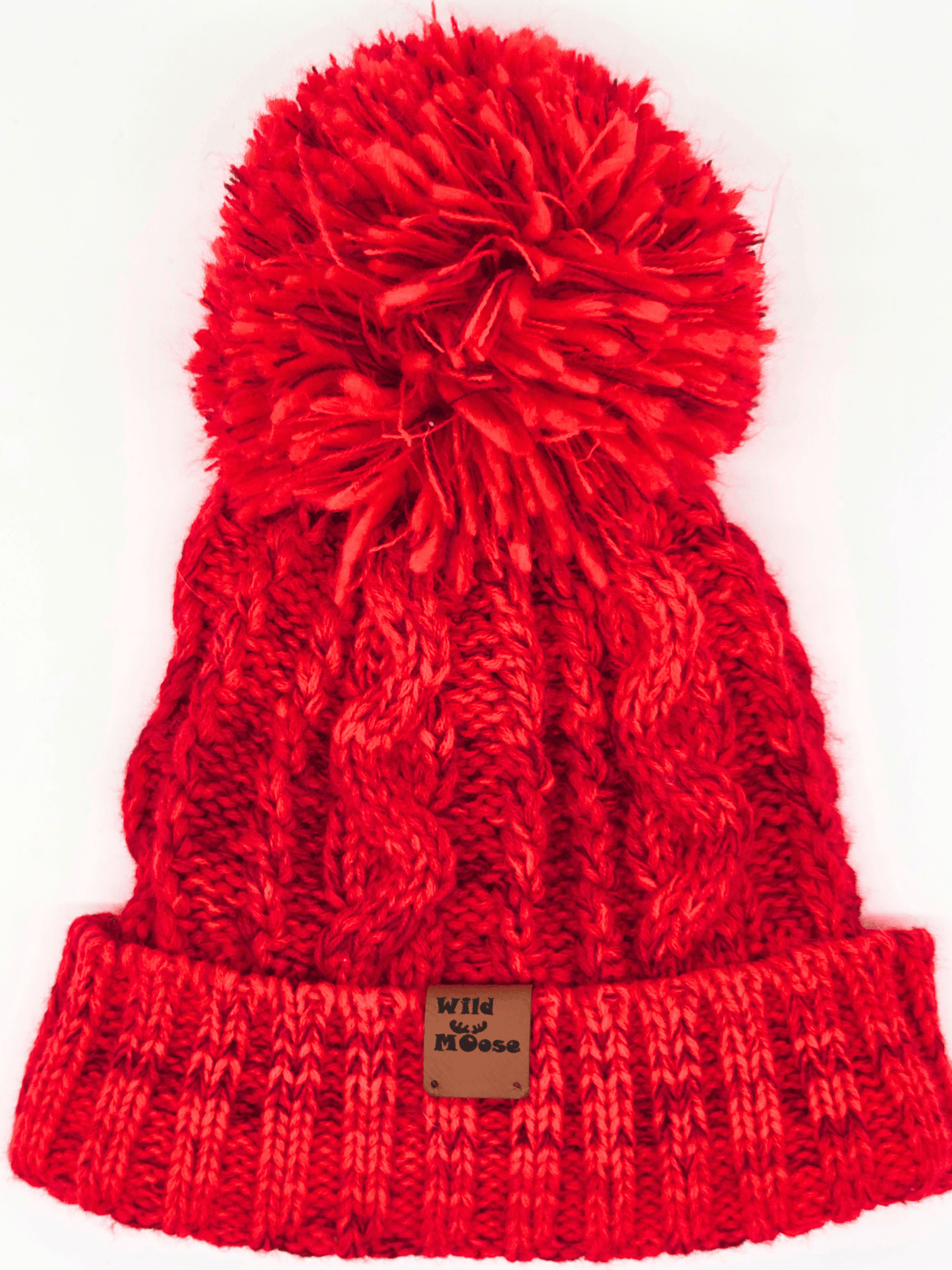 red knitted beanie with a red pom-pom on a white background.