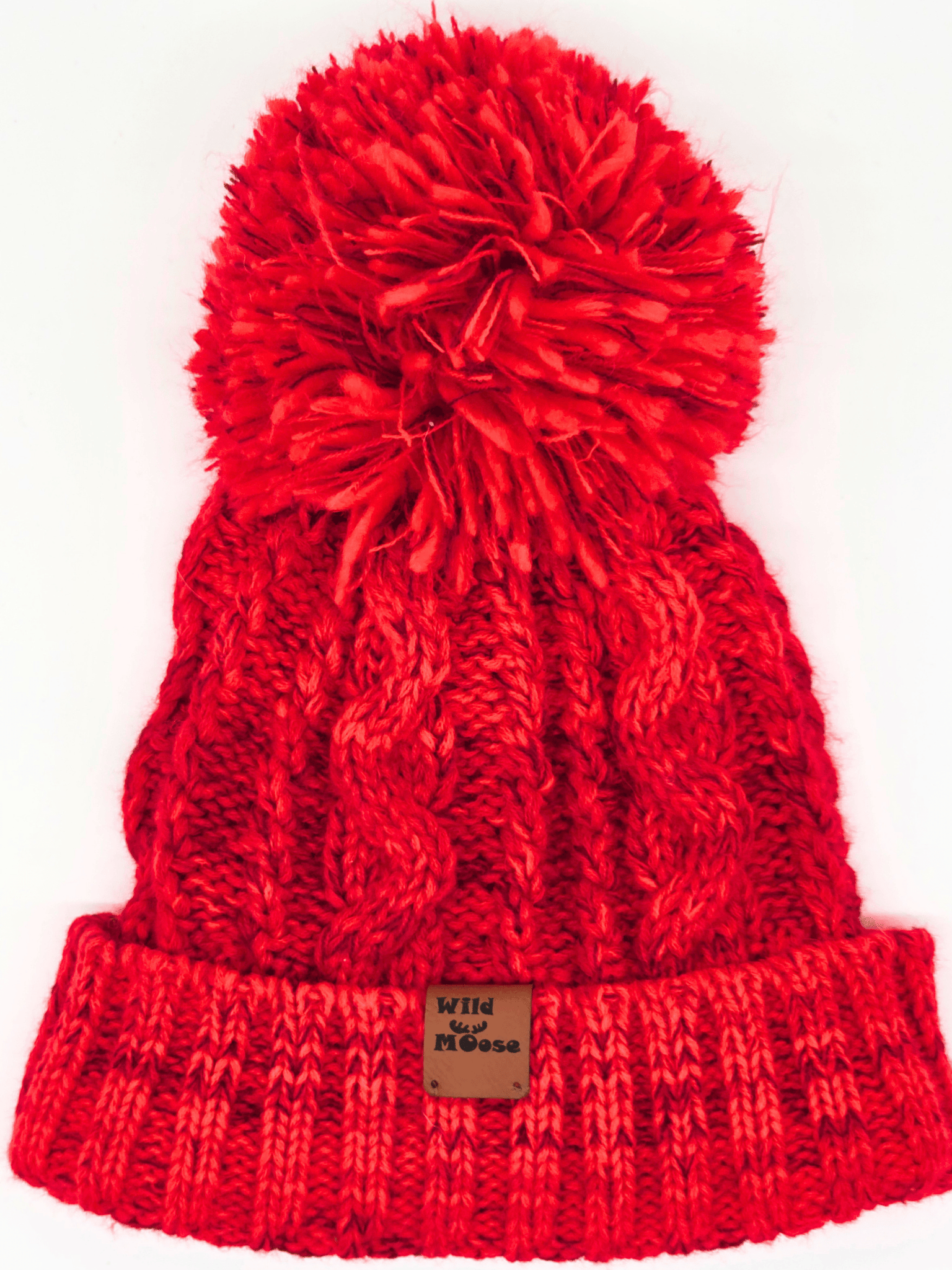 red knitted beanie with a red pom-pom on a white background.