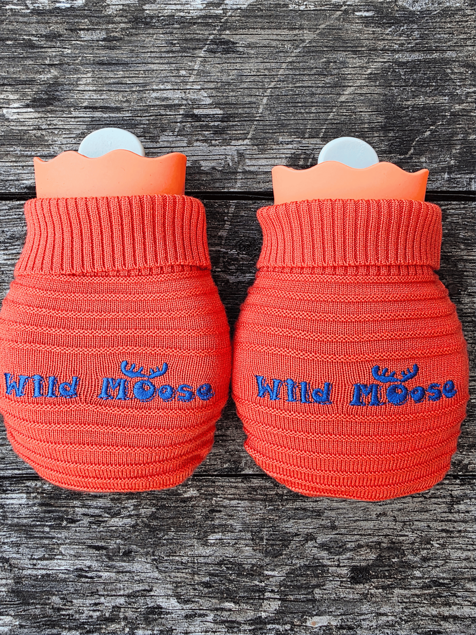 2 mini hot water bottles in a knitted cover - both bright orange