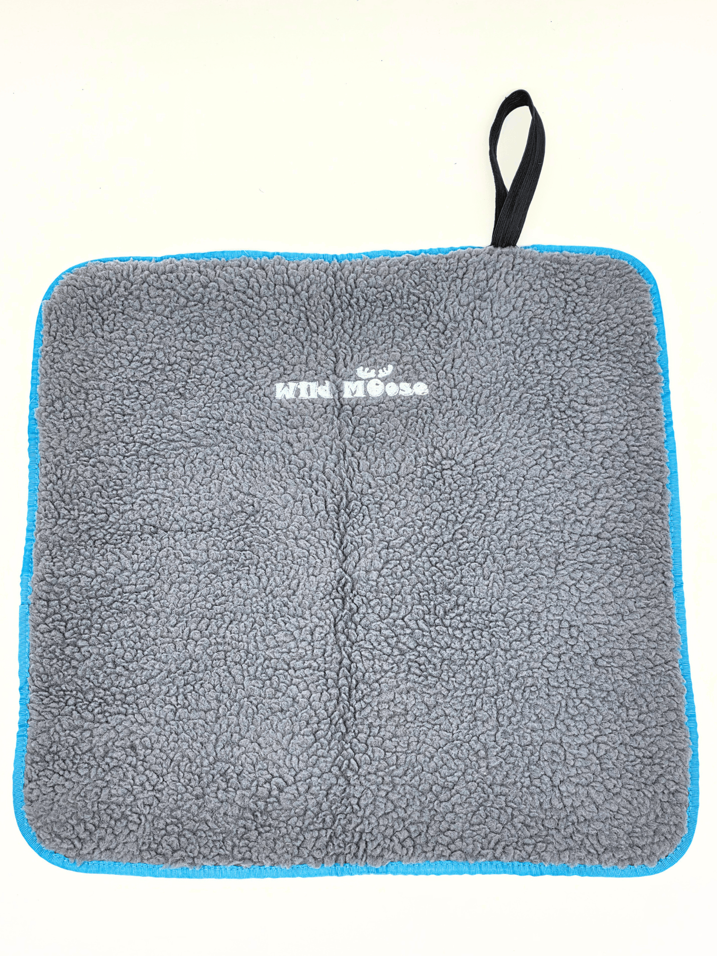 grey fleece lined changing mat with "wild moose" branding near the top on a white backdrop.