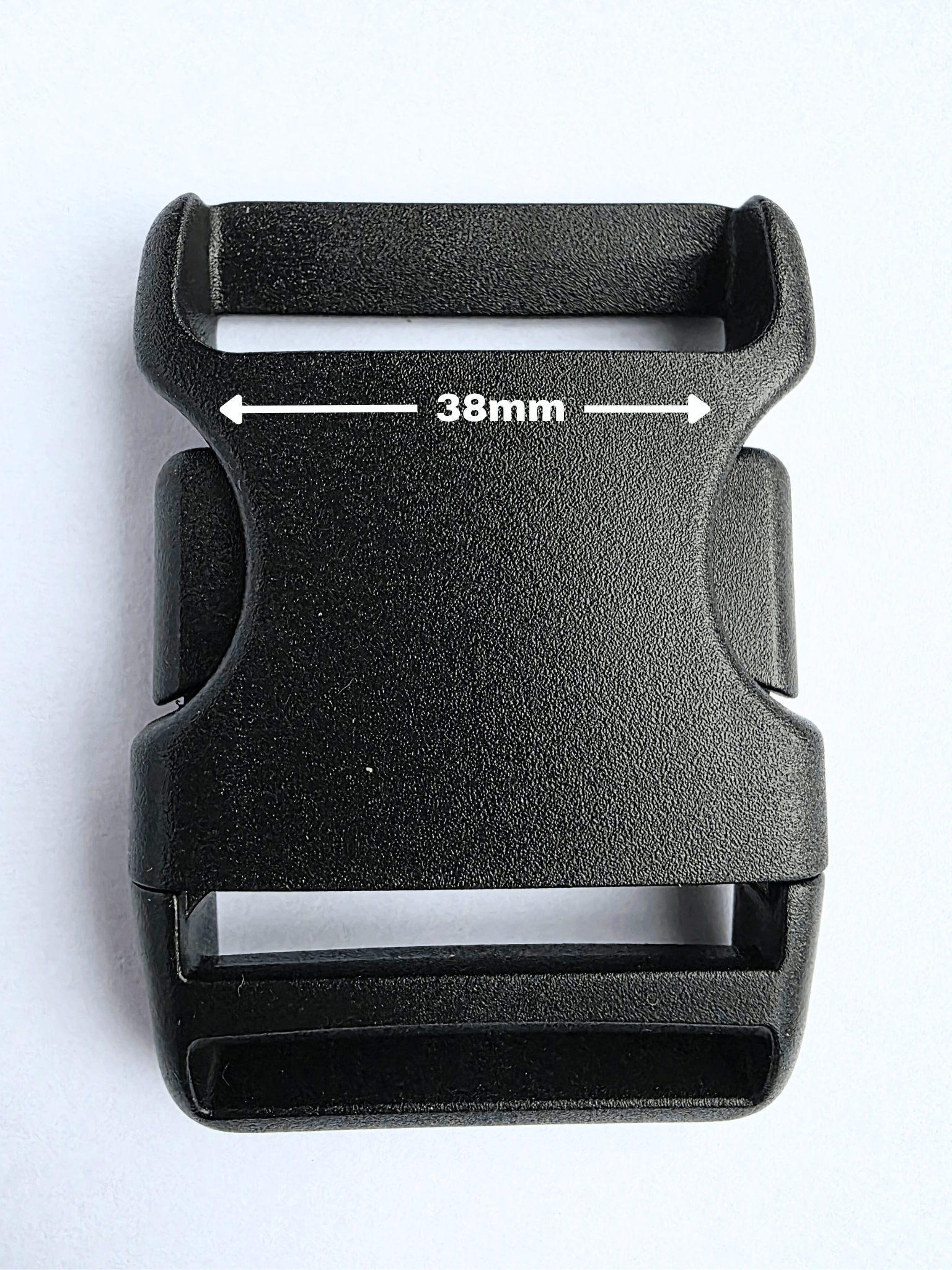 Black, plastic side release buckle showing width of strap at 38mm